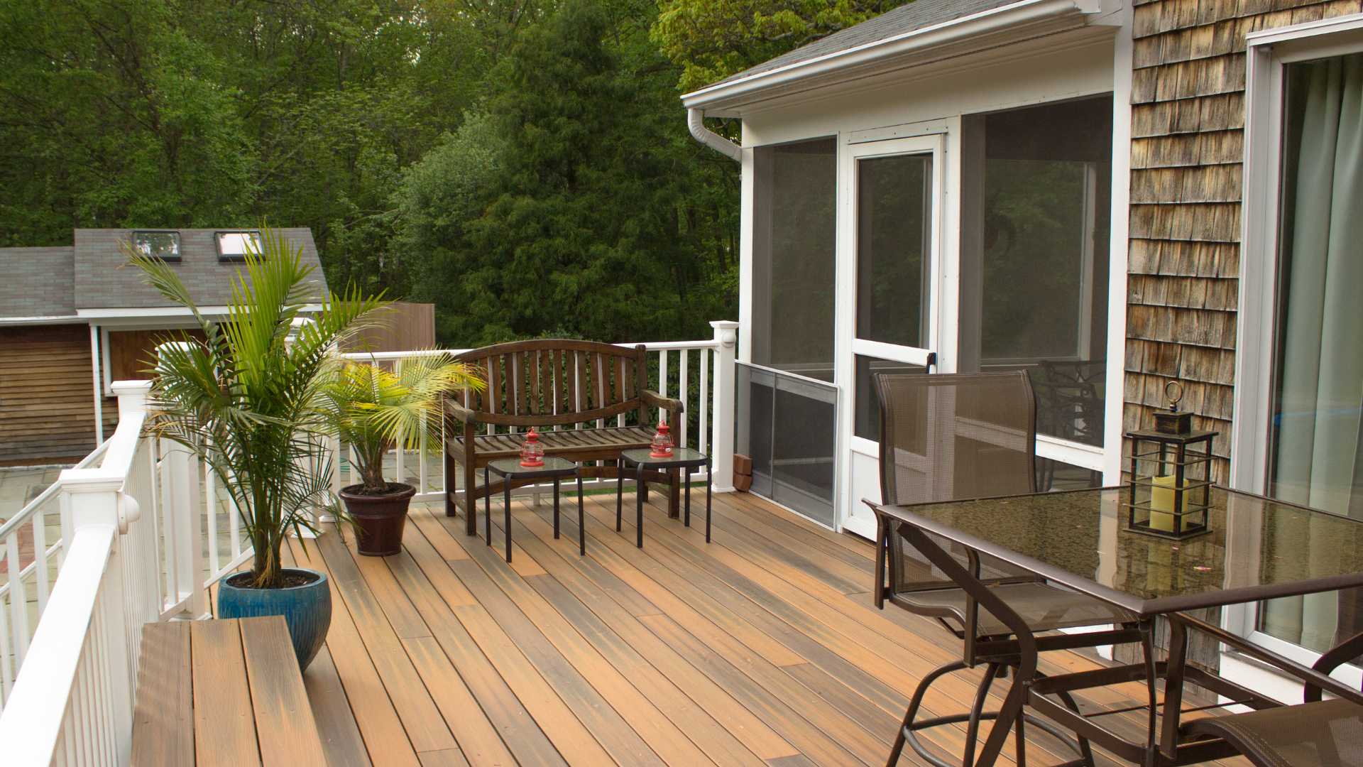 A custom-designed modern multi-level wooden deck seamlessly integrated with the historic brick exterior of an Alexandria City home.